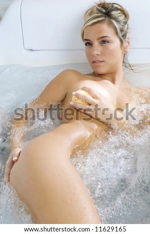 stock photo cute naked blond inside a jacuzzi bathtub relaxing herself