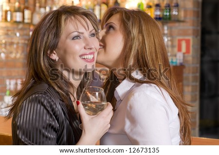 two attractive woman near a bar drinking and talking about their secrets