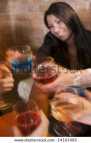 group of young people in a pub with glass in hand customer attention the image is out of focus