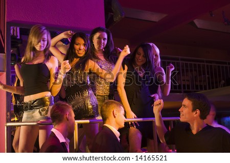 people dancing in a club. a disco night club dancing