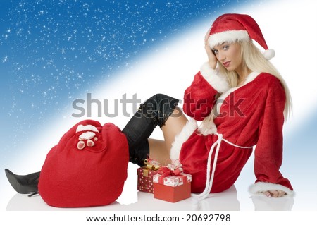sensual blond santa claus with gift sack and black boot sitting tired