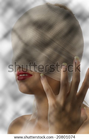 portrait of woman with bandage around face and scared hand