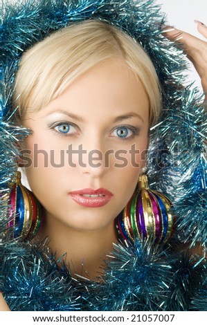 woman with old christmas ball as earring and boa around face