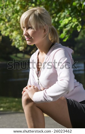 blond girl making gymnastic in a sunny day outdoor