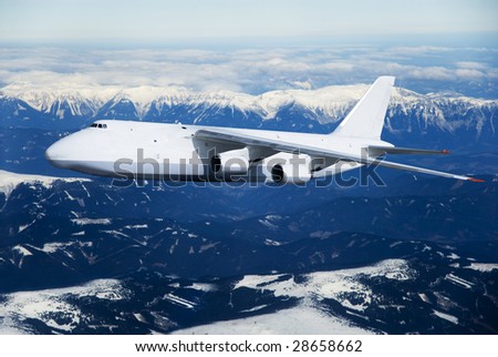cargo airplane in fly with mountain with snow on background