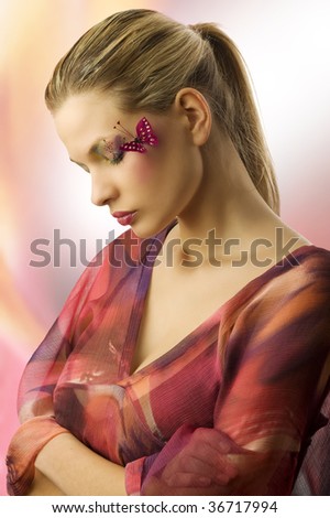 one side view of cute woman with closed eyes and creative make up with a butterfly