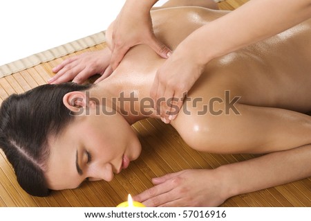 attractive beautiful caucasian woman lying down and getting a massage with oil on wood carpet