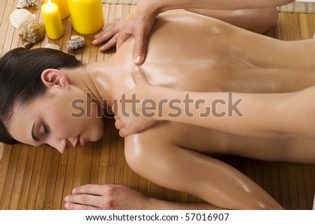 attractive beautiful caucasian woman lying down relaxing herself and getting a massage with oil
