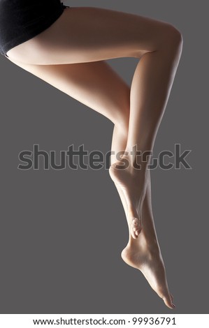 Long shaved pretty woman legs isolated with a fashion light