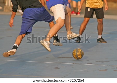 People enjoying a game of football (soccer)