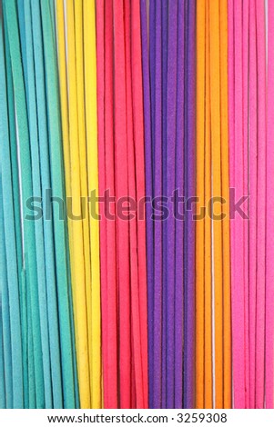 Colorful incense sticks organized as a background