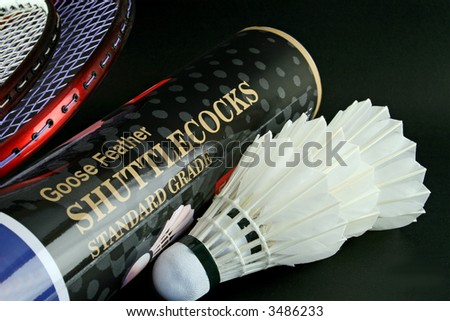 Badminton shuttles and rackets isolated on a black background