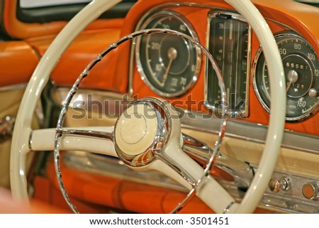 Close up of the steering wheel of a classic old car