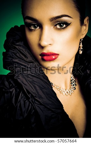 Beautiful fashion girl on the green background