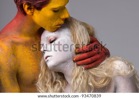 beautiful couple hugging people in the paint bodyart