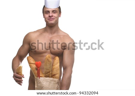 A handsome smiling man with bodybuilder physique holding a brown paper bag of baguettes concealing his loins, implied nude.