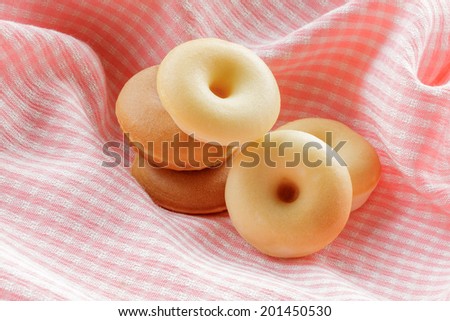 group of doughnut with pink cloth background.