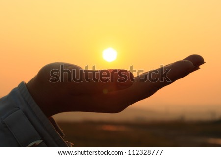 The sunset in hand. Abstract photography in backlit