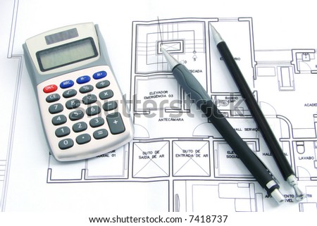 Still life composition with a calculator pen and pencil over a construction plan