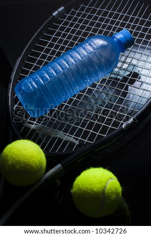Bottle of water and tennis balls over racket