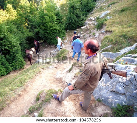 TROPOJE, KOSOVO, 19 JULY 1998 - A Kosovo Liberation Army (UCK) smuggler brings weapons across the border from neighboring Albania using horses.