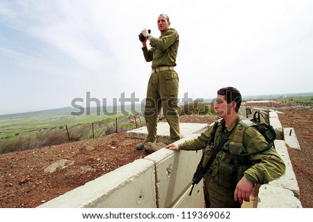 HAR KACHAL, ISRAEL - MARCH 28:  Israeli defense force (IDF) soldiers look over the border into the Syrian village of Kumeitra high into the Golan Heights on March 28, 2000 in Golan Heights Israel.