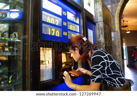 KIEV - AUGUST 16: A woman changes money at a kiosk in Kiev, Ukraine, on August 16, 2003.