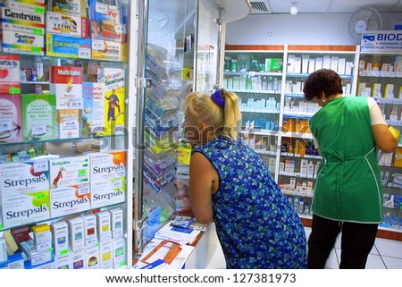 KIEV - AUGUST 16: People wait on line at a local privately owned pharmacy in Kiev, Ukraine , on August 16, 2003.