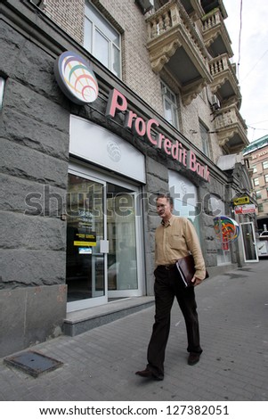 KIEV - JULY 12: A man walks by a ProCredit Bank in Kiev, Ukraine, on Wednesday, July 12, 2006. ProCredit Bank specializes in providing financing to micro, small and medium-sized enterprises.