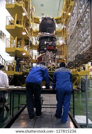 BAIKONUR COSMODROME - OCTOBER 30: Russian engineers go over blueprints for the Progress M1 spacecraft in the RSC Energia vehicle assembly building at the Baikonur Cosmodrome in Baikonur, Kazakhstan.