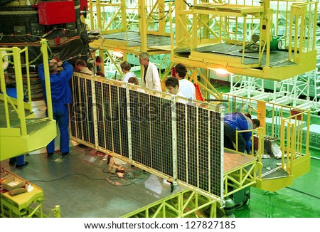 BAIKONUR COSMODROME - OCTOBER 29 2000:  Russian space technicians and engineers test the solar array on a Progress M1 spacecraft in the RSC Energia vehicle assembly building in Baikonur, Kazakhstan.