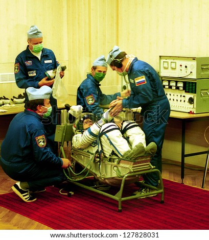 BAIKONUR COSMODROME - OCTOBER 31: US astronaut William Shepherd, commander of the first mission to the international space station gets suited up by Russian ground staff on October 31, 2000.
