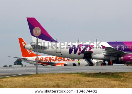 BUDAPEST - JUNE 12: A WizzAir airplane on the tarmac at Ferihegy International Airport in Budapest, Hungary, on Sunday, June 12, 2005. Behind it is an airplane of budget carrier EasyJet.