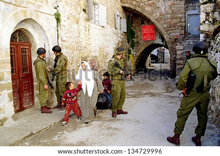 HEBRON - DECEMBER 15: Soldiers of the Israeli army\'s 101st Airborne Division Apache Platoon patrol the streets of Hebron on December 15, 1999.