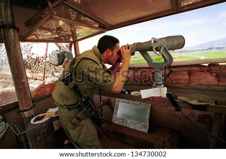 MARJAYOUN - MARCH 22 An Israeli defense force (IDF) soldier looks out over southern Lebanon from an observation post near the Israeli Lebanese border on March 22, 2000.