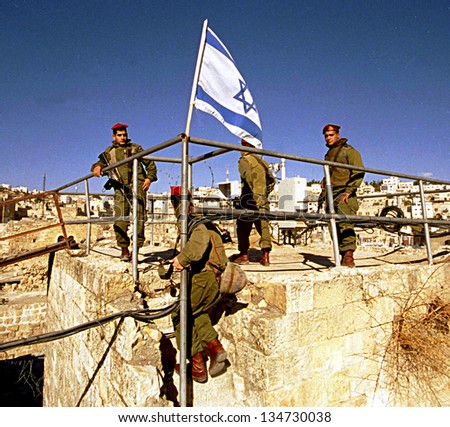 HEBRON - DECEMBER 15: Soldiers of the Israeli army\'s 101st Airborne Division Apache Platoon patrol the streets of Hebron on December 15, 1999.