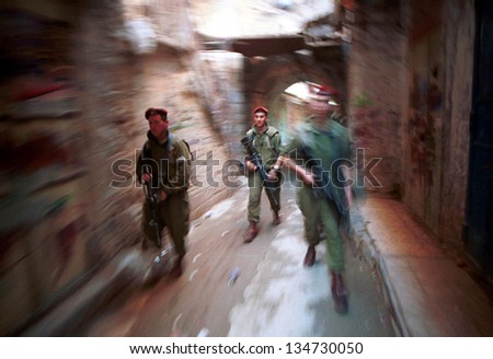 HEBRON - DECEMBER 15: Soldiers of the Israeli army's 101st Airborne Division Apache Platoon patrol the streets of Hebron on December 15, 1999.