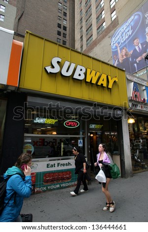 NEW YORK CITY - APRIL 19: People walk past a Subway sandwich shop in New York City, on Friday, April 19, 2013.