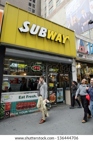 NEW YORK CITY - APRIL 19: People walk past a Subway sandwich shop in New York City, on Friday, April 19, 2013.
