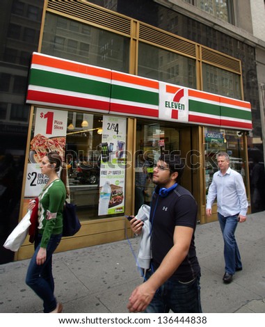 NEW YORK CITY - APRIL 19: People walk past a 7-11 convenience store in New York City, on Friday, April 19, 2013.