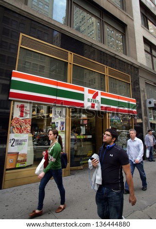 NEW YORK CITY - APRIL 19: People walk past a 7-11 convenience store in New York City, on Friday, April 19, 2013.