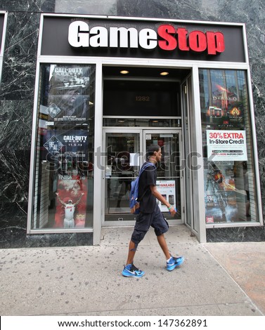 NEW YORK CITY - JULY 8: Shoppers walk past a GameStop retail store in New York City, New York, on Monday, July 8, 2013. GameStop Corp. is an American video game and entertainment software retailer.