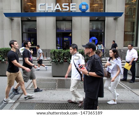 NEW YORK CITY - JULY 11: Pedestrians walk past a branch office of  Chase Bank in lower Manhattan on Thursday, July 11, 2013.  JPMorgan Chase & Co. is an American multinational bank.
