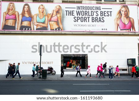 NEW YORK CITY - OCT 24 2013: Pedestrians walk past an outdoor advertisement and store for Victoria\'s Secret in Manhattan on Sunday, October 20, 2013.