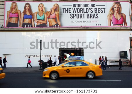 NEW YORK CITY - OCT 24 2013: Pedestrians walk past an outdoor advertisement and store for Victoria\'s Secret in Manhattan on Sunday, October 20, 2013.