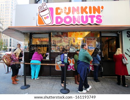 NEW YORK CITY - OCT 20 2013: People line up for coffee and donuts at a Dunkin\' Donuts store in Manhattan on Sunday, October 20, 2013.