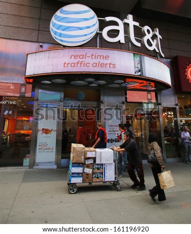 NEW YORK CITY - OCT 17:  Pedestrians walk past an AT&T Wireless Services, Inc.  retail outlet in Manhattan on Thursday, October 17, 2013.