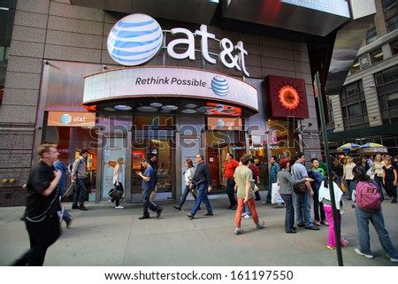 NEW YORK CITY - OCT 17:  Pedestrians walk past an AT&T Wireless Services, Inc.  retail outlet in Manhattan on Thursday, October 17, 2013.