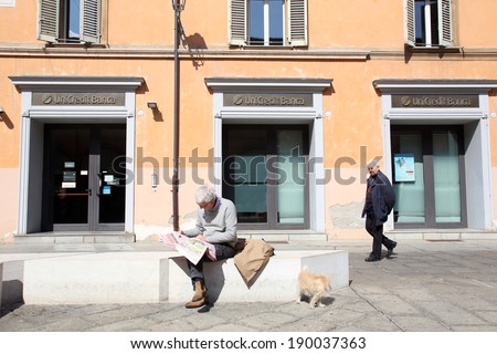 BOLOGNA, ITALY - APRIL 19, 2014: A man walks past a  Unicredit Banca di Roma S.p.A bank office in Bologna, Italy, on Saturday, April 19, 2014.