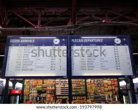 BUCHAREST, ROMANIA - MAY 15, 2014:  Pedestrians walk past the departure and arrival board at the Gare de Nord train station in Bucharest, Romania, on Thursday, May 15, 2014.